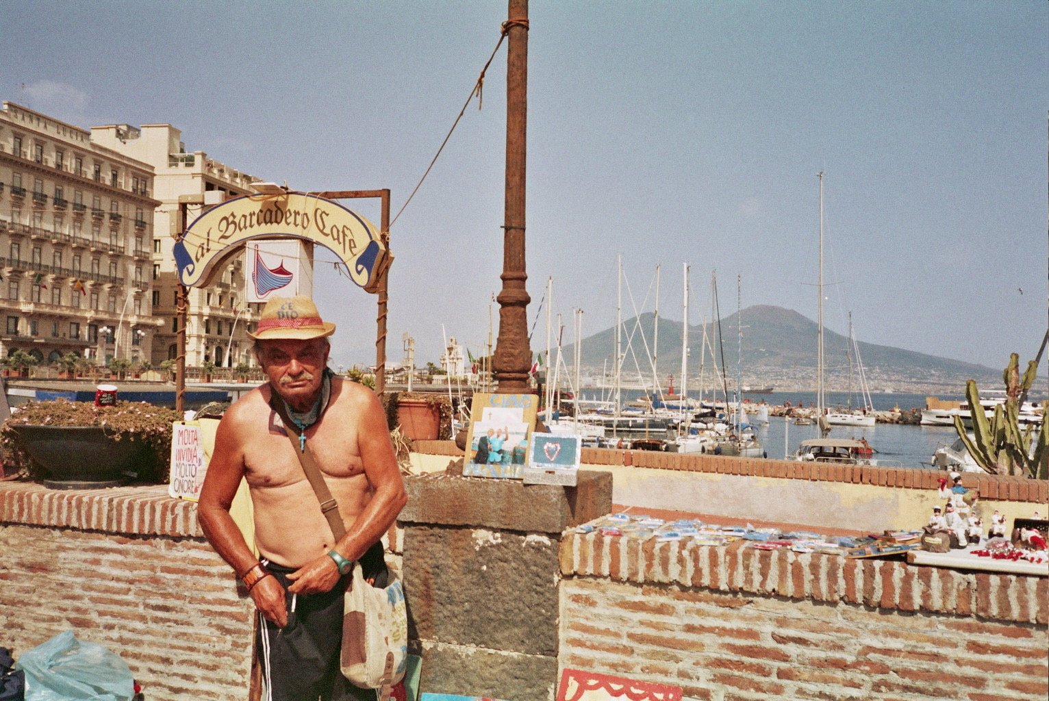 Portrait of a man by the Naples waterfront with Mount Vesuvius and sailboats in the background