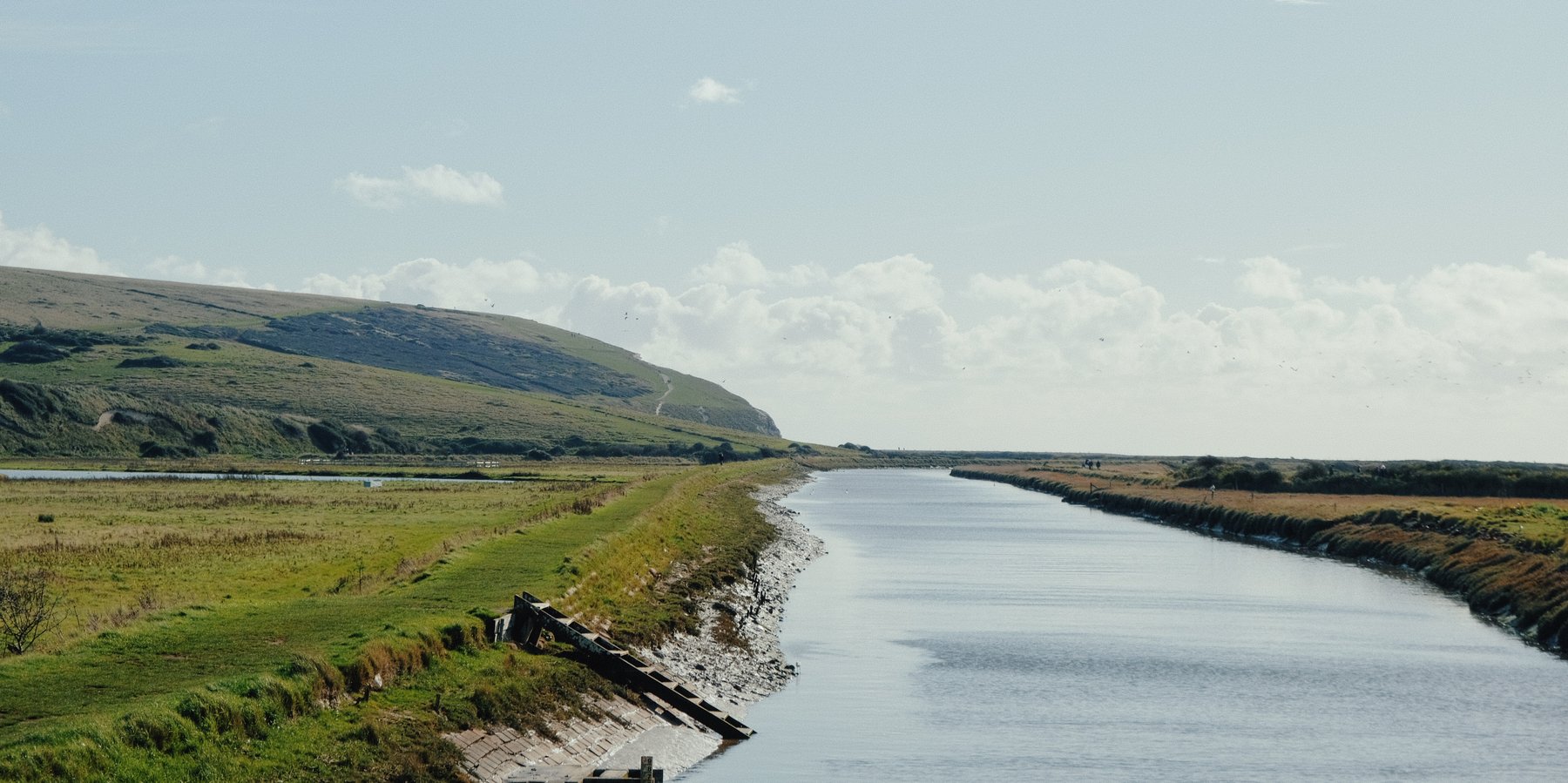 Green river valley landscape beneath a cloudy sky
